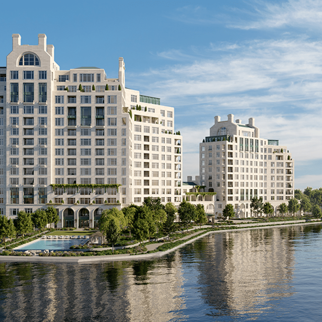 Waterfront view of two modern high-rise buildings.